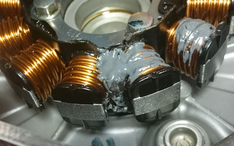 Refixing the modified stator wires using JB-Weld. The 5 minute epoxy that was used originally couldn't handle high temperatures. The patch wire was also rerouted to minize the risk of scraping on the flywheel.