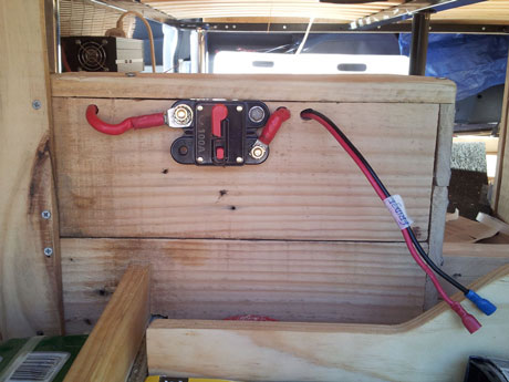 The 'house' battery box made from Pallet wood, with the 100Amp main fuse and fridge connector.